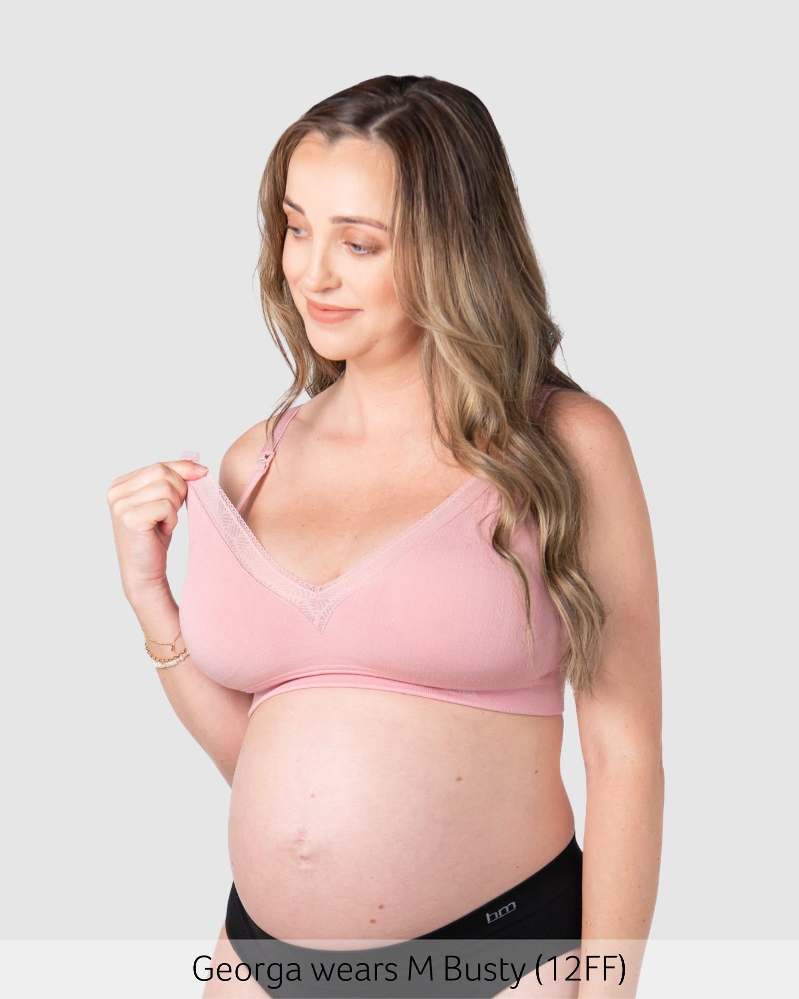 Pregnant woman wearing maternity bra caress by hotmilk