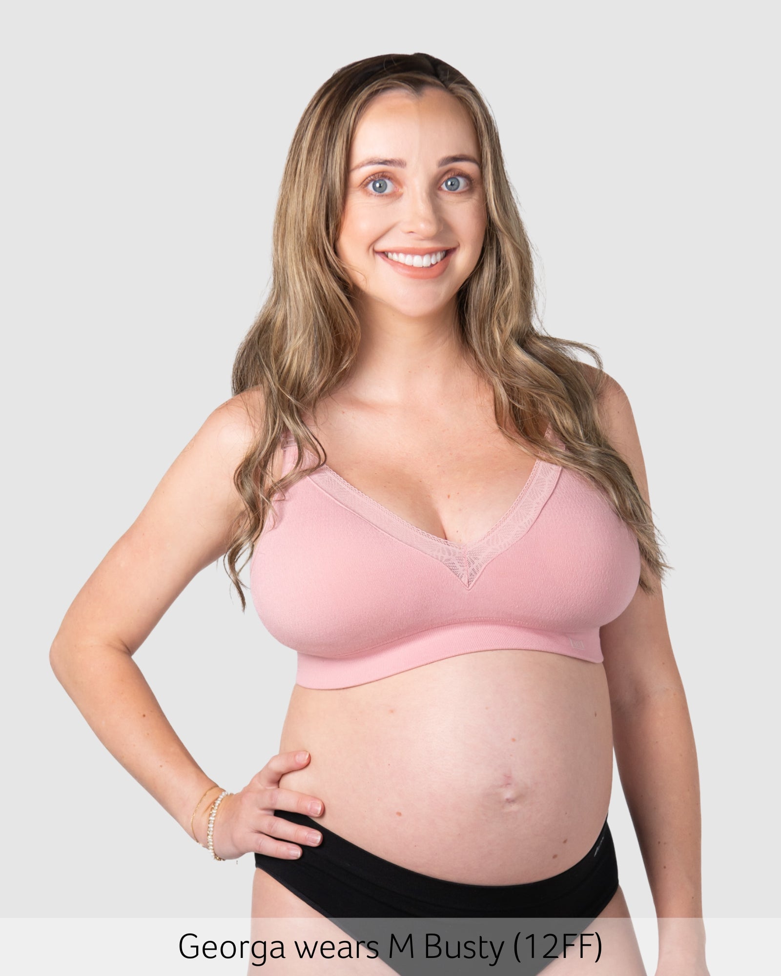 Pregnant woman wearing maternity bra caress by hotmilk