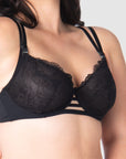 Take a closer look at the True Luxe by Hotmilk Lingerie NZ in black, showcasing its contemporary twin strap detailing, semi-sheer full cup coverage, and flexi underwire support. The modern signature magnetic nursing clips and center cutouts elevate this style to the next level of sophistication. Embrace empowerment throughout your breastfeeding journey with this exquisite bra, designed to accommodate cup sizes up to J cup, without making any compromises