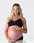 Pregnant model wearing the Hotmilk Caress FlexFit Nursing Bra in Black with matching briefs – front view showing wirefree silhouette, lace trim neckline, and supportive fit during pregnancy