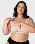 Model demonstrating pull-aside nursing access on the Hotmilk My Comfort Nursing Bra in Oat – showing easy side-access breastfeeding functionality