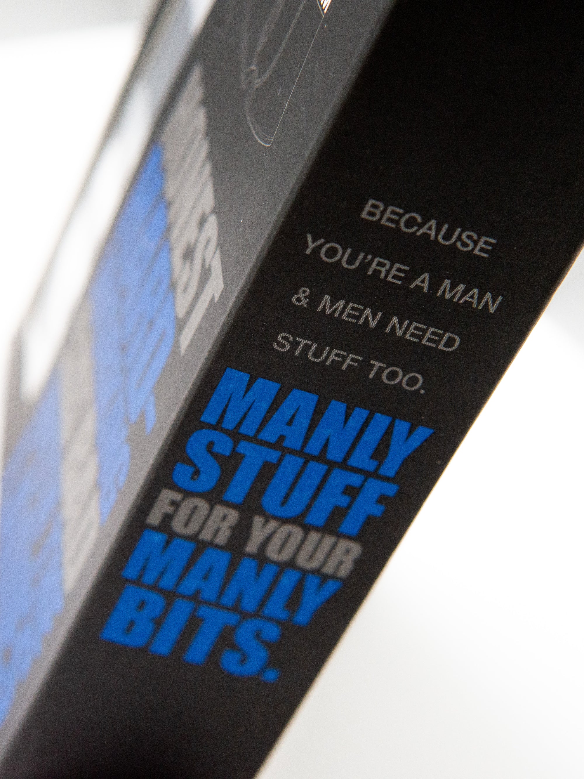Product packaging with humorous text about men's items on a white background