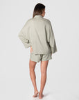 Get a glimpse of the back view of Hotmilk's versatile mix-and-match collection as it flawlessly combines the Lounge Top with the Lounge Short, creating the ultimate ensemble for warm days and evenings. These garments are impeccably crafted from a soft linen blend in a serene Sage color, promising a comfortable fit with elegant 3/4 length kimono-style sleeves. This set epitomizes the seamless blend of luxury and comfort, perfectly addressing the requirements of pregnancy, breastfeeding, and postpartum care