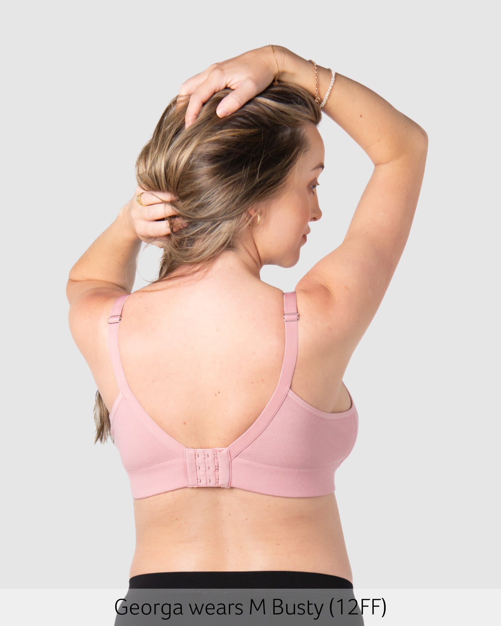 Pregnant woman wearing maternity bra caress by hotmilk