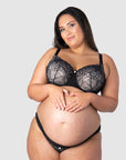 Tiare flaunts Hotmilk's celebrated Temptation nursing and maternity set, showcasing the Temptation Maternity Briefs designed to be worn under the bump. These perfectly match the Temptation Flexiwire Nursing Bra, sheer black lace over nude, a delicate elegance ideal for encapsulating the spirit of maternity photoshoot