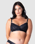 Experience the pinnacle of comfort and style as Olivia embraces the Warrior Soft Cup in Black by Hotmilk Lingerie. This wire-free maternity and nursing bra embodies a flawless fusion of lightness and youthfulness, boasting rose gold magnetic nursing clips and sheer graphic lace for a modern touch. Immerse yourself in the seamless blend of comfort and style, elevating this modern maternity essential to a must-have