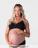 Pregnant model wearing the Hotmilk Caress FlexFit Nursing Bra in Black with matching briefs – front view showing wirefree silhouette, lace trim neckline, and supportive fit during pregnancy