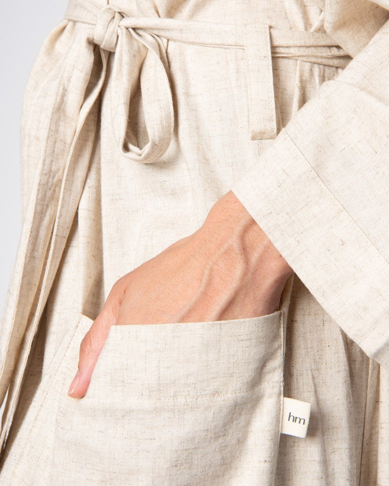 Experience a close-up view of Hotmilk's opulent Linen Blend Robe, showcasing deep pockets, a tie waist, and stylish 3/4 kimono-style sleeves. This robe serves as the perfect addition to Hotmilk's mix-and-match maternity and postpartum loungewear collection, tailored for both breastfeeding and nursing mothers